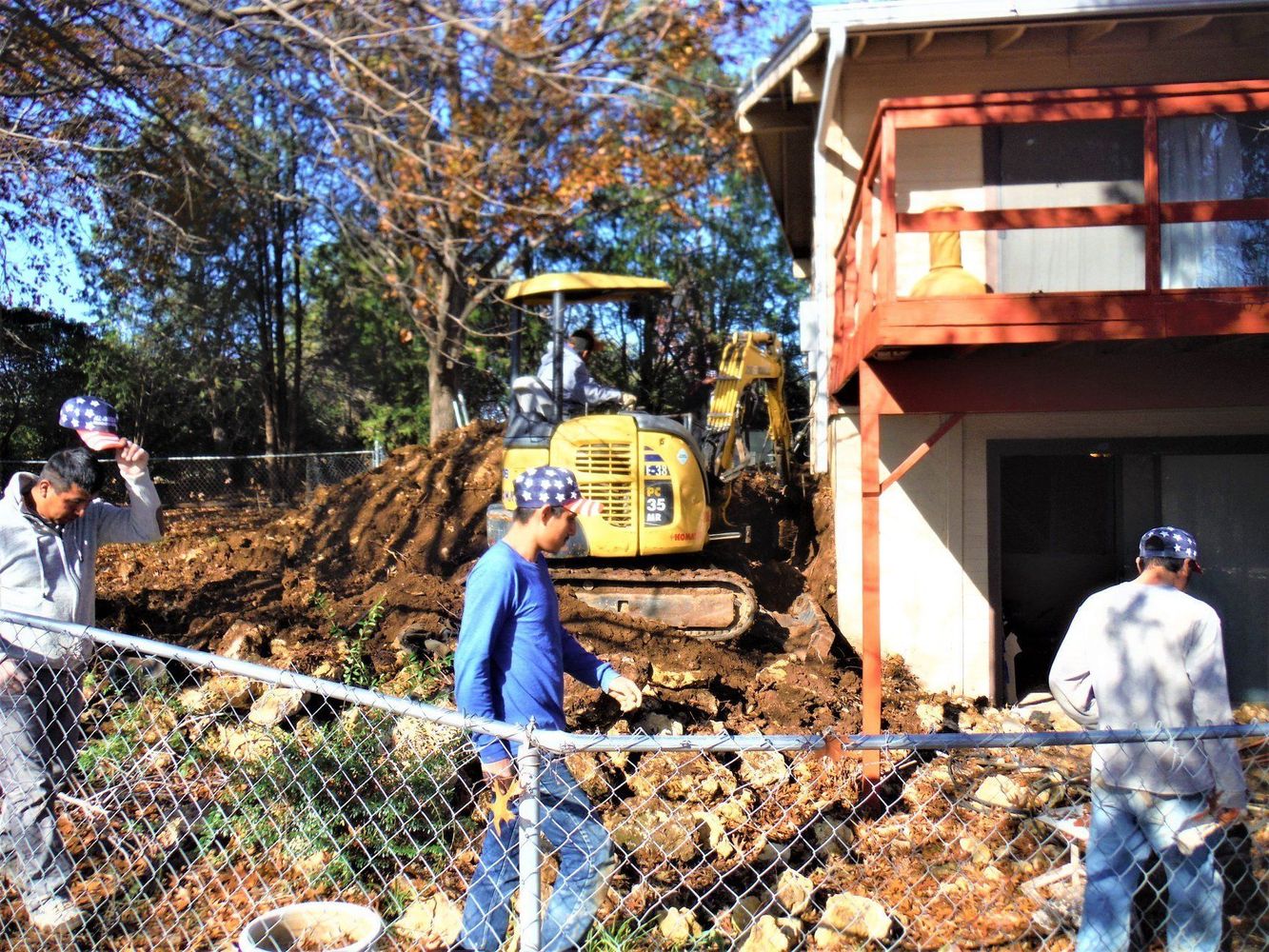 Workers preparing site with excavator
