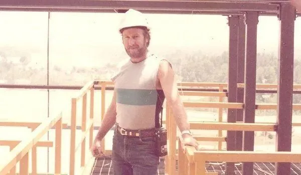 Worker standing on building framework