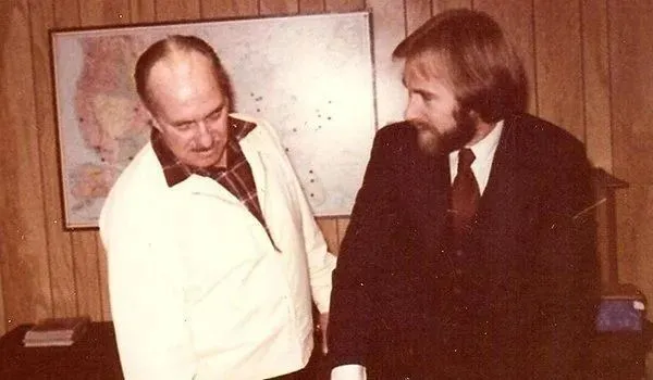 Men in conversation near a map