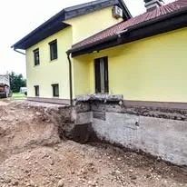 Excavation beside yellow house