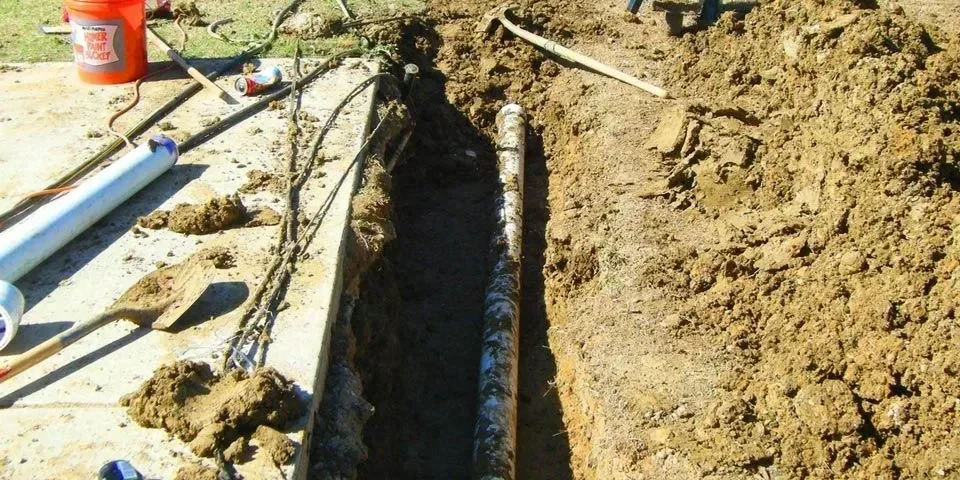 Construction site with tools and trench